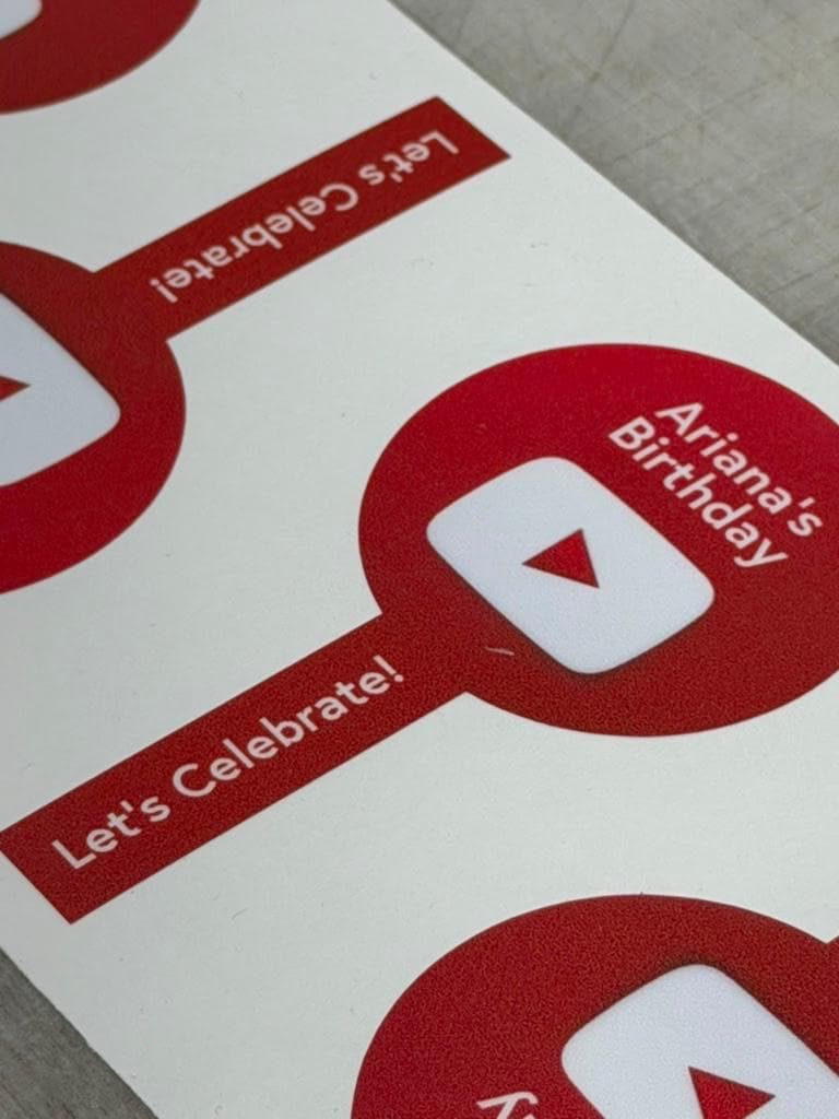 A close view of a red Ariana's Birthday sticker