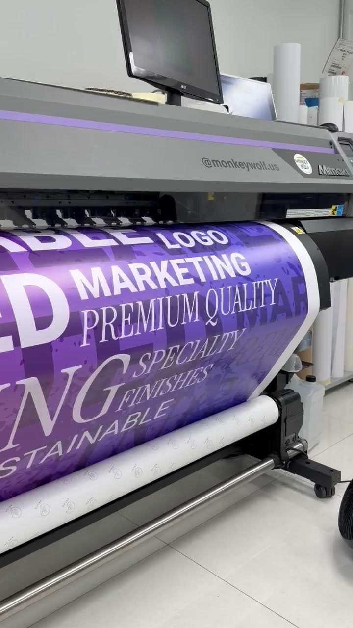 A purple banner reading Premium Quality emerging from the machine