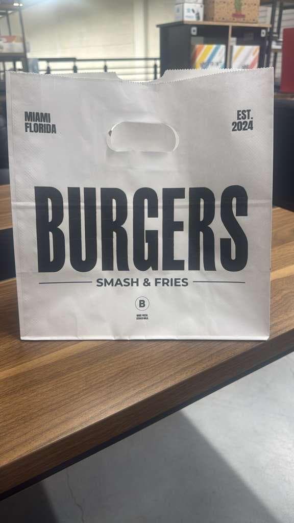 A white paper bag printed for Burgers Smash & Fries