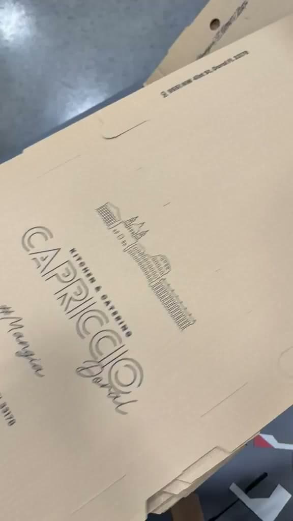 A kraft catering box printed with the Capriccio wordmark