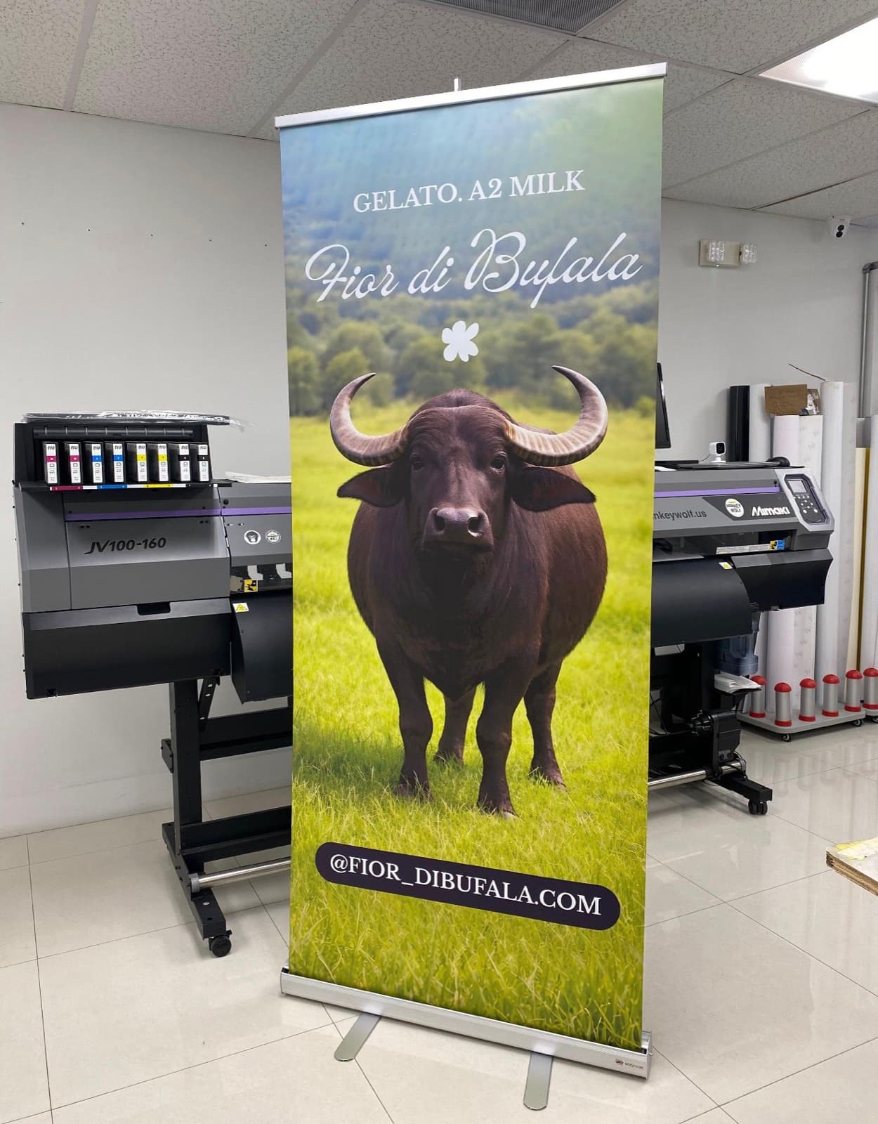 A Fior di Bufala retractable banner beside the printer