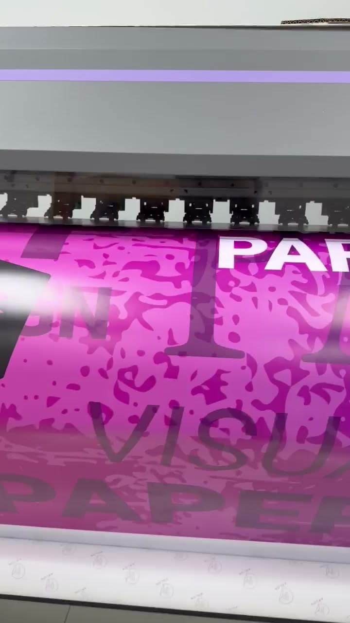 A magenta wide-format run passing through the printer